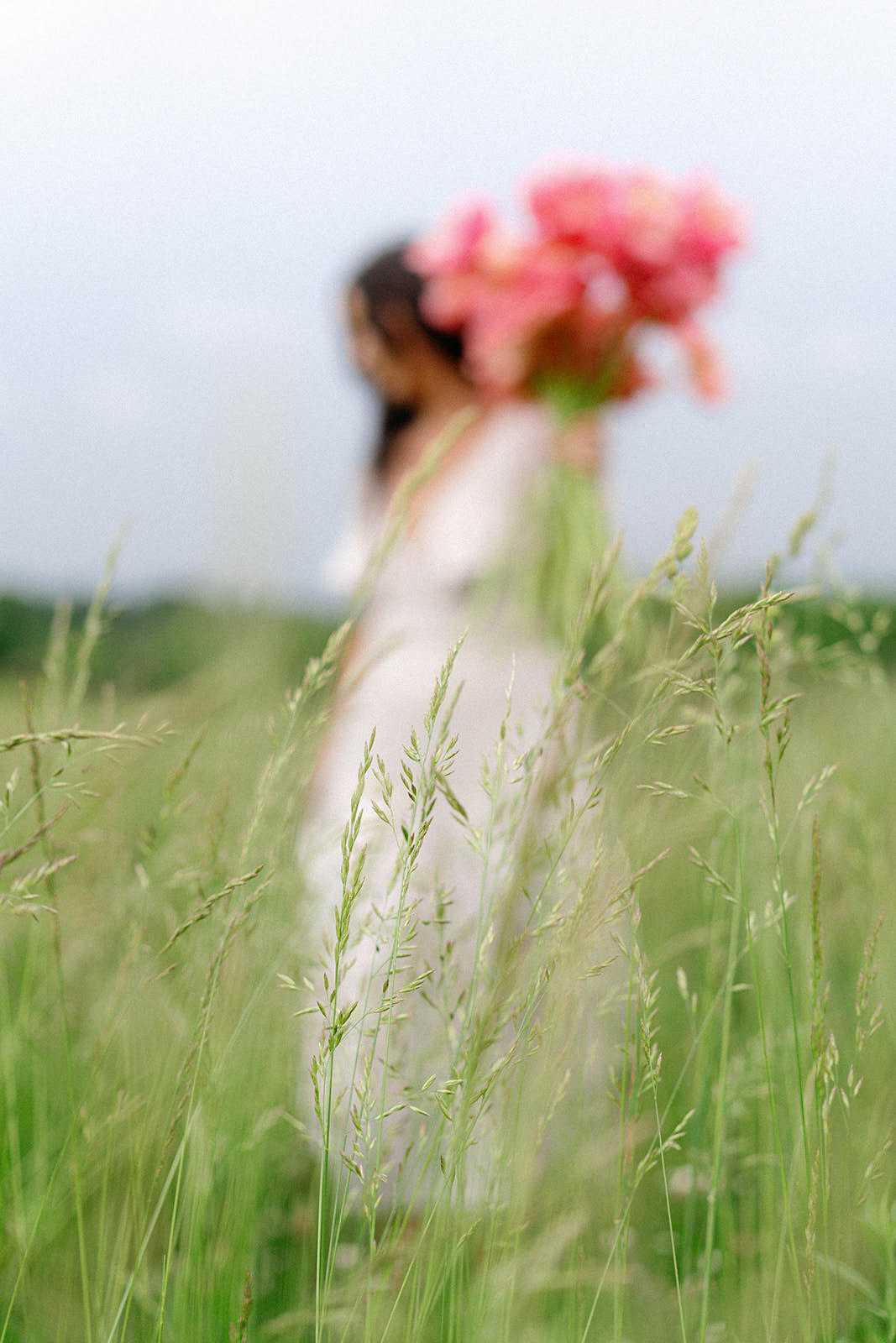 Sarina posing with a bouquet of flowers