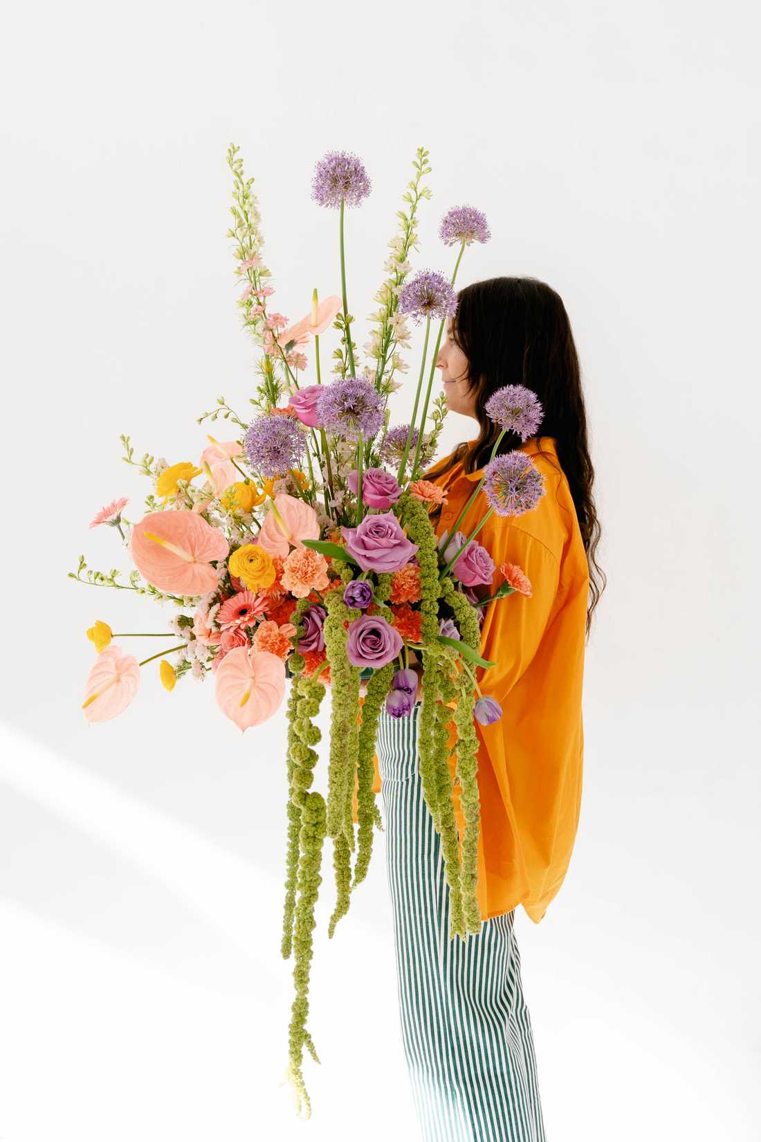 Sarina posing with a bouquet of flowers